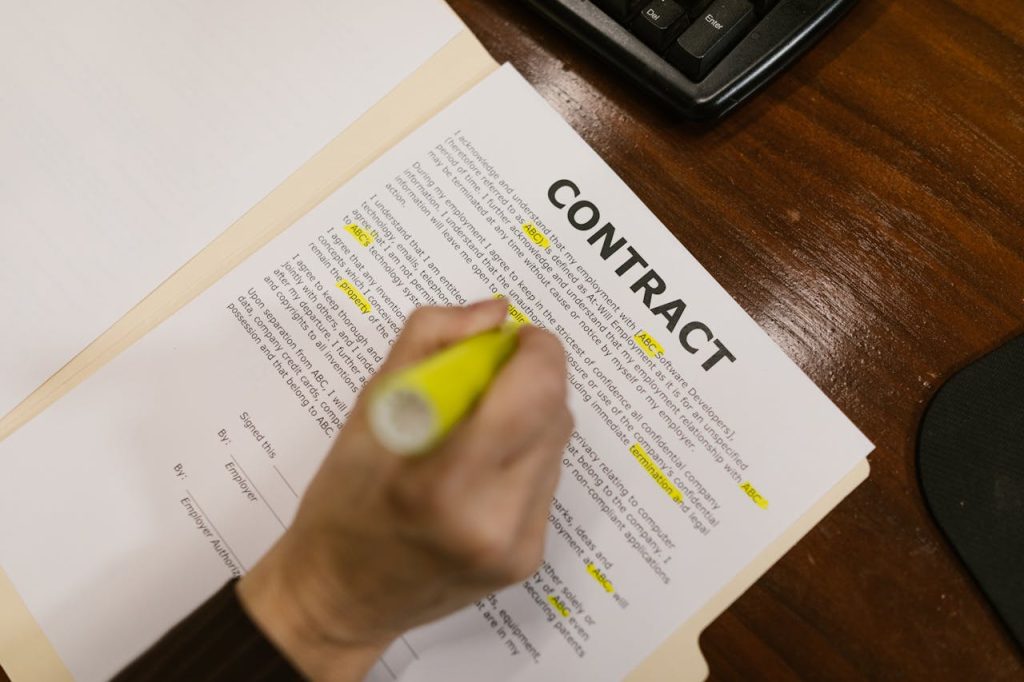 Popular Regional Slang from Around the World Focused view of a person highlighting text in a contract document on a wooden office desk.